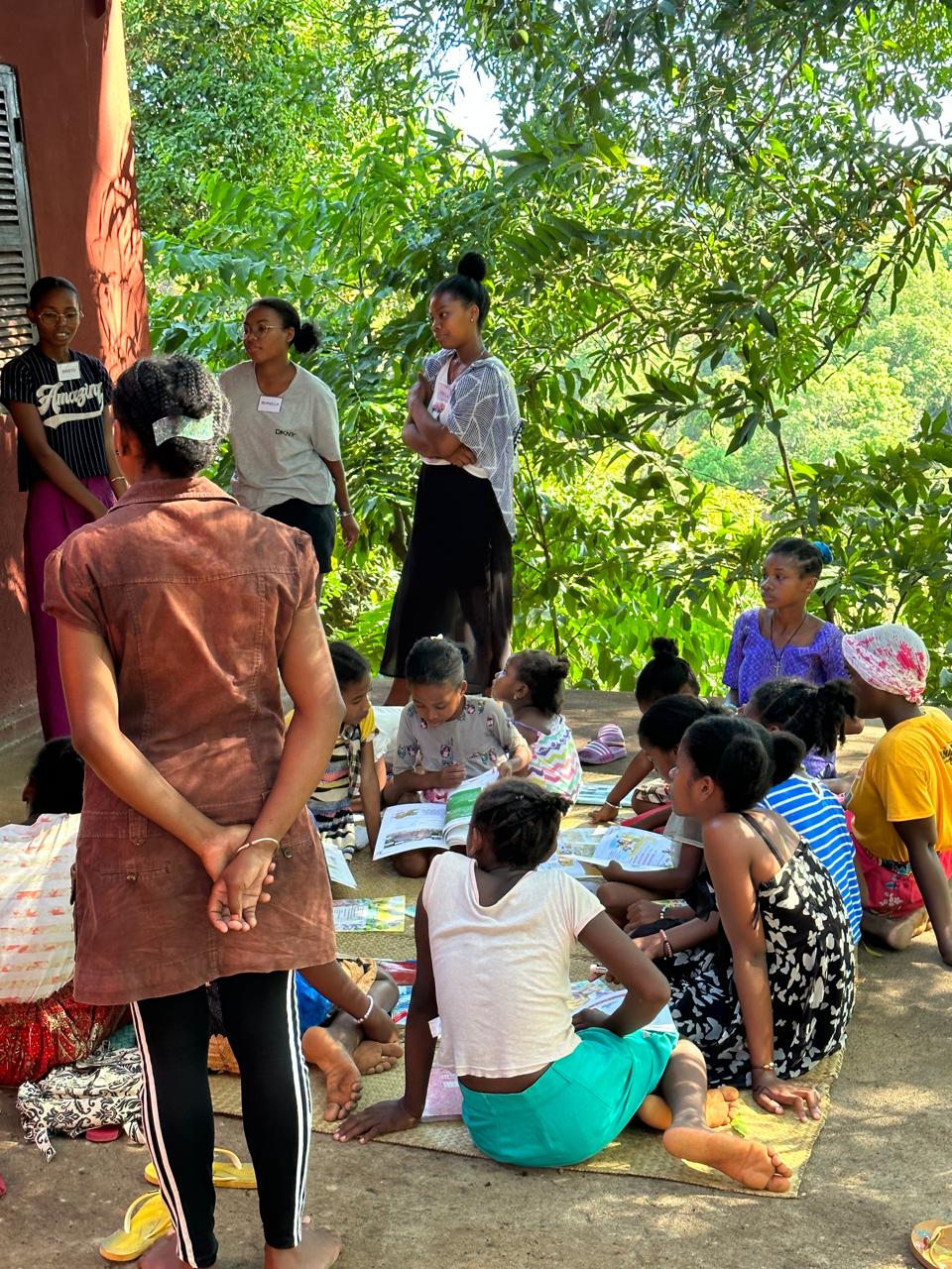 Wings of Change students in Madagascar working through workbooks in an outdoor class